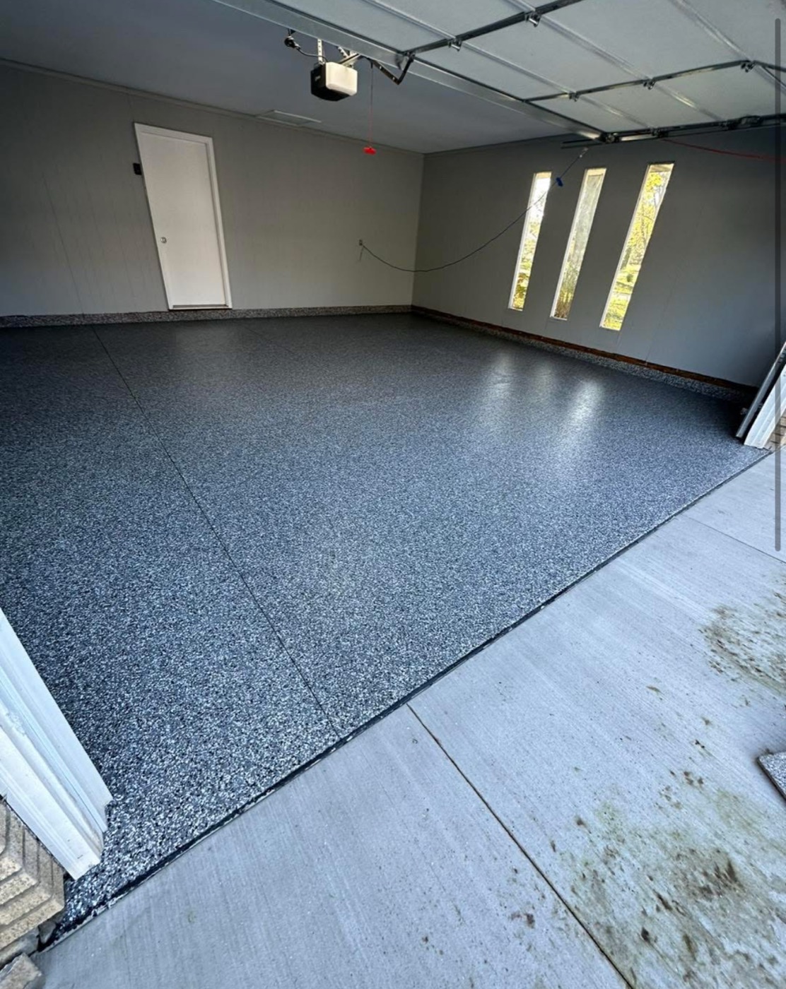 After: dark flake epoxy coating on garage floor