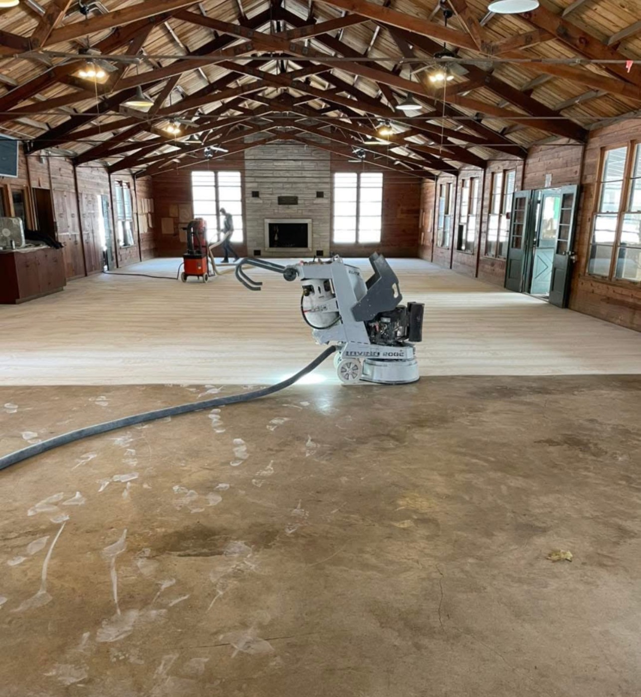Before: bare concrete floor being ground and prepped